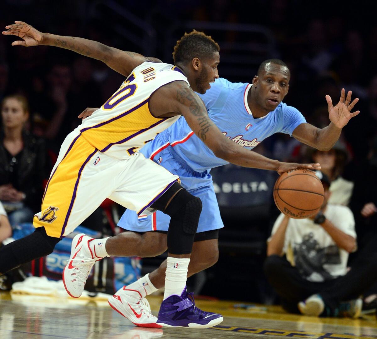 Clippers guard Lester Hudson, right, defends against Lakers guard Dwight Buycks on April 5.