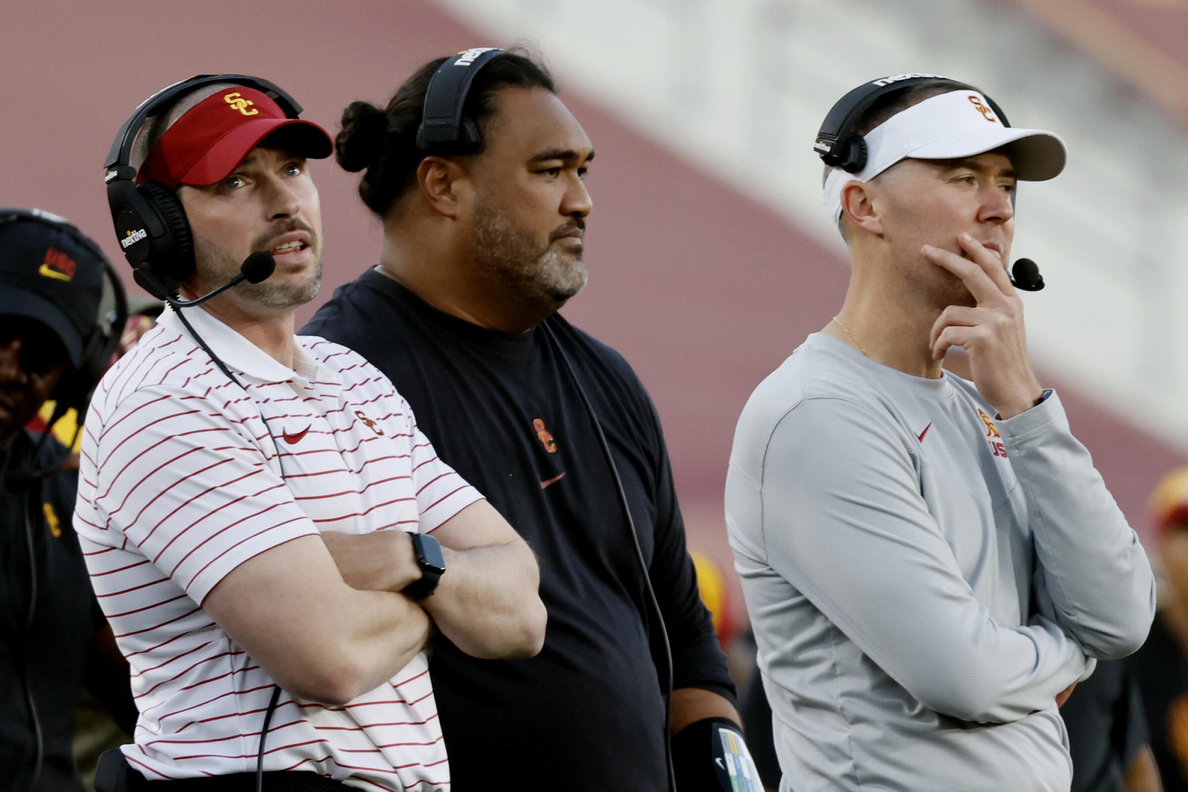 USC defensive coordinator Alex Grinch, left, stands next to coach Lincoln Riley.