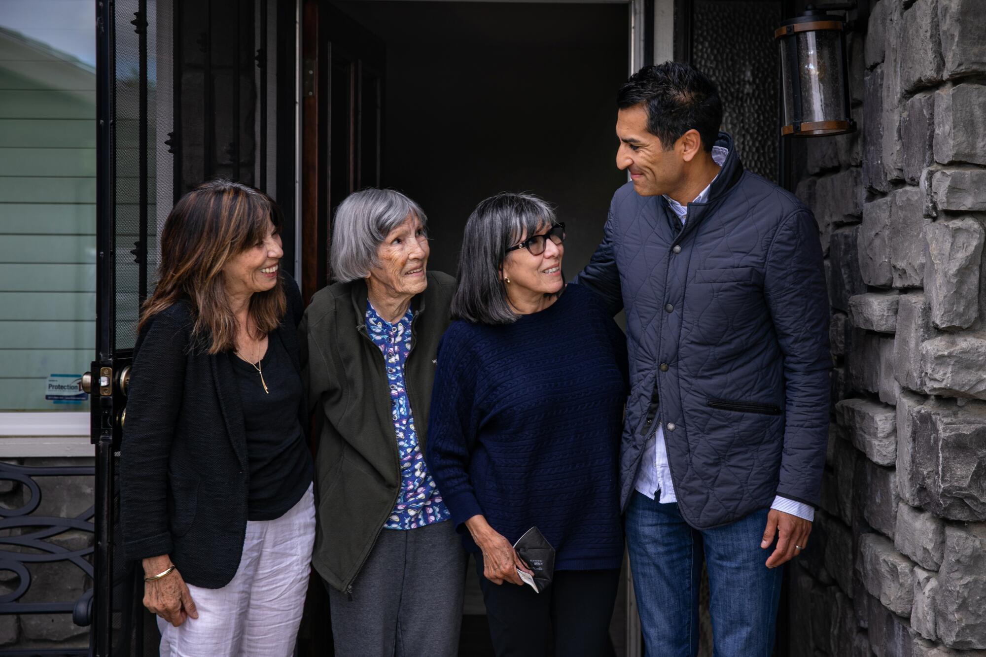 Assembly Speaker Robert Rivas in front of his childhood home in Hollister with his mother, grandmother and aunt.