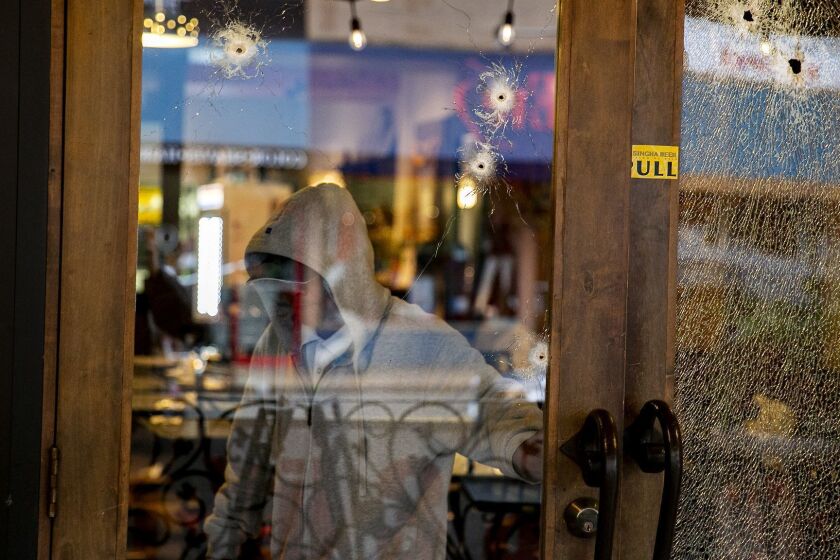 SAN DIEGO, CALIFORNIA, February 13, 2019 | Bullet holes pierced the glass in front of The Asian Bistro restaurant in Hillcrest after a suspect released a "hail of gunfire" into the restaurant. On Wednesday, people surveyed the damage inside the store. | PHOTO/SAM HODGSON Staff photographer, San Diego Union-Tribune. Â©2019