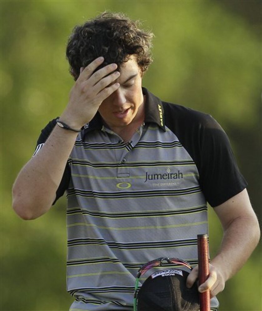 FILE - This April 10, 2011, file photo shows Rory McIlroy wiping his forehead after his final round of the Masters golf tournament, in Augusta, Ga. The first time McIlroy recalls watching the Masters on TV was 1996 when one of his golf idols, Nick Faldo, shot 67 in the final round to overcome a six-shot deficit. (AP Photo/David J. Phillip, File)