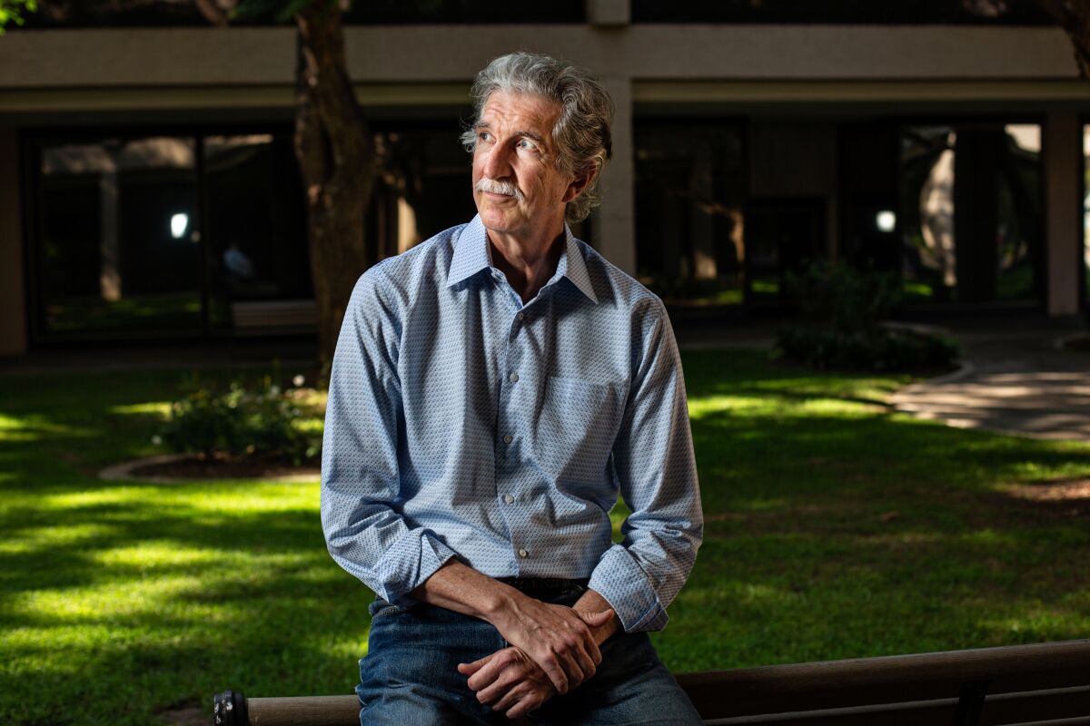 Paul Murdoch sits in a garden outside of his office in Los Angeles