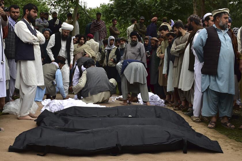 Dead bodies of Afghan people are placed on the ground after heavy flooding in Baghlan province in northern Afghanistan Saturday, May 11, 2024. Flash floods from seasonal rains in Baghlan province in northern Afghanistan killed dozens of people on Friday, a Taliban official said. (AP Photo/Mehrab Ibrahimi)