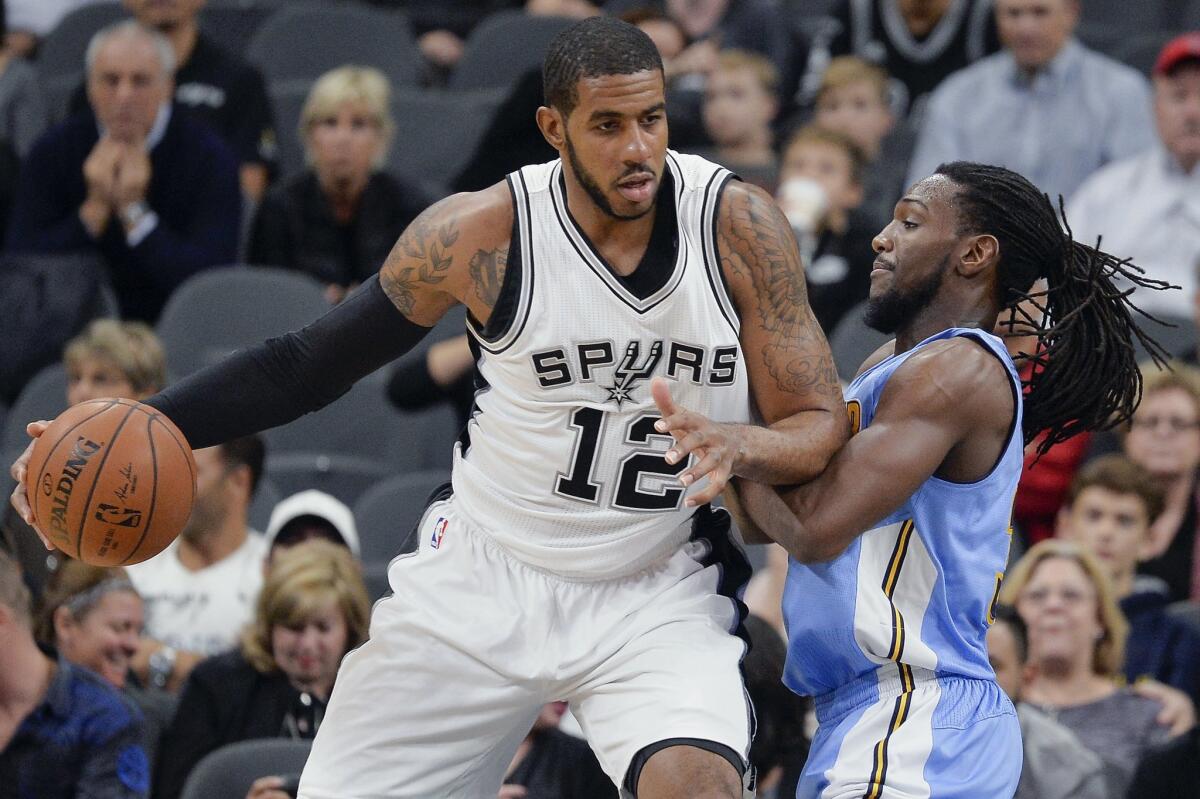 San Antonio's LaMarcus Aldridge, left, drives around Denver's Kenneth Faried on Nov. 18.