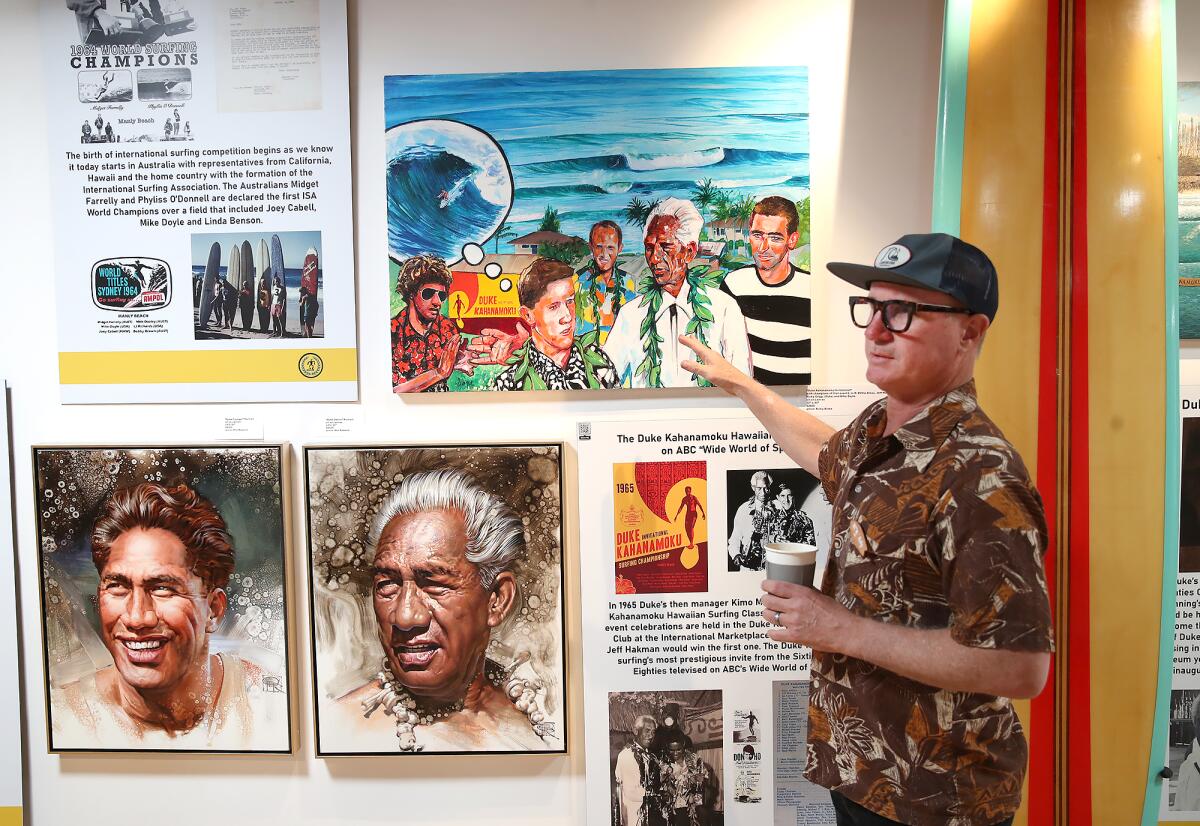 Ricky Blake shows some of the artwork reflecting the image and legacy of Duke Kahanamoku at the new exhibit.