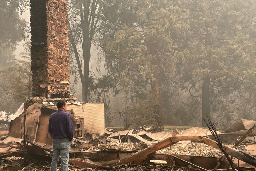 Plumas County Supervisor Kevin Goss looks at a friend's home incinerated in the Dixie fire.
