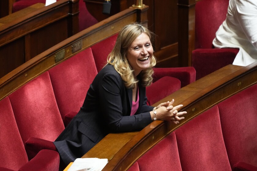 Yaël Braun-Pivet, a member of the centrist alliance Ensemble (Together) smiles at the National Assembly, Tuesday, June 28, 2022 in Paris. France's lower house of parliament opened its first session since President Emmanuel Macron's party lost its majority, and elected a woman, Yael Braun-Pivet, as speaker for the first time. (AP Photo/Michel Euler)