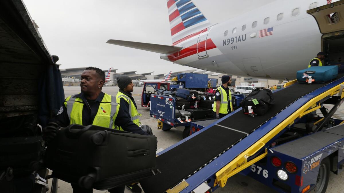 Workers unload baggage from an American Airlines plane at Los Angeles International Airport. The nation's biggest carriers had the highest rating last year for airline quality in the 27-year history of a Wichita State University study.