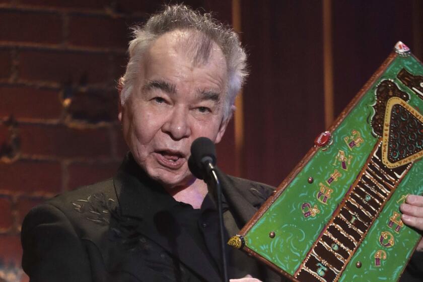 John Prine accepts the artist of the year award during the Americana Honors and Awards show Wednesday, Sept. 12, 2018, in Nashville, Tenn. (AP Photo/Mark Zaleski)