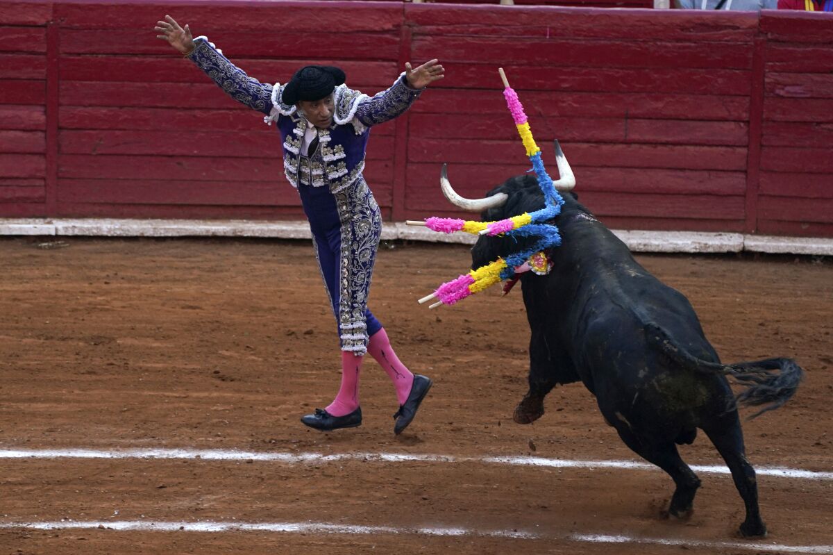 FILE - A bullfighter nails two "banderillas" on a bull at the Plaza de Toros, in Mexico City, Feb. 20, 2022. A Mexican judge issued an injunction against bullfighting in Mexico City on Friday, May 28. The constitutional injunction orders that no fights be held until after a hearing early June. (AP Photo/Fernando Llano, File)