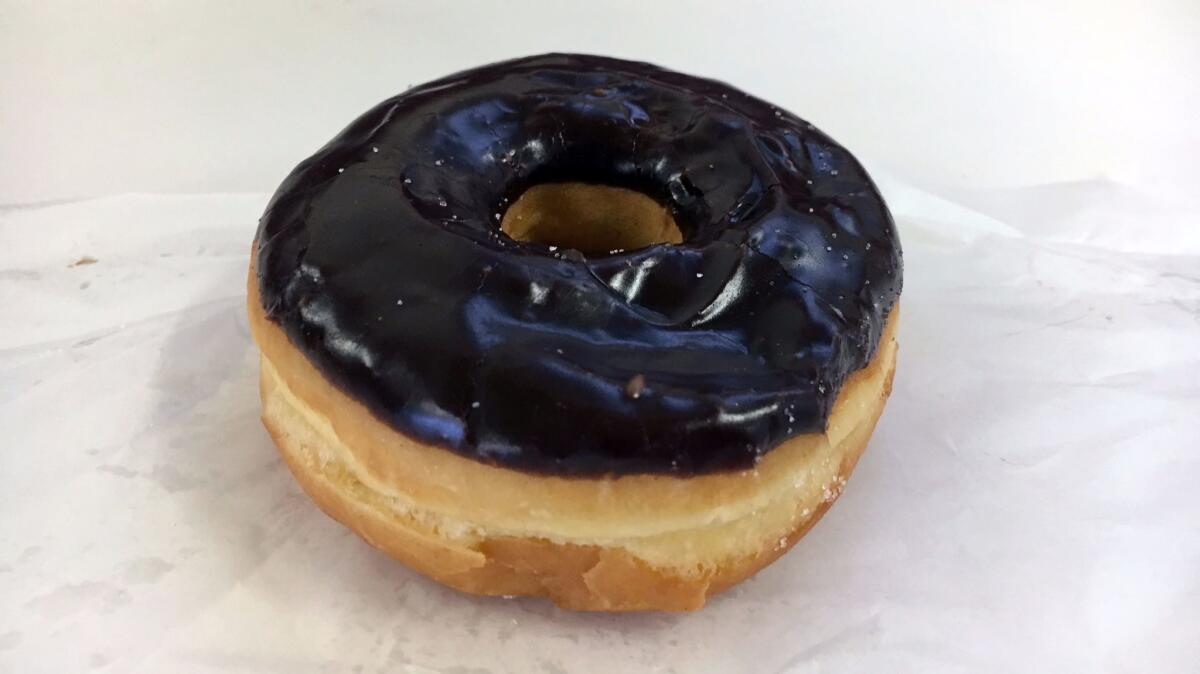 Chocolate-glazed doughnut from Bob's Coffee and Doughnuts. (Jenn Harris / Los Angeles Times)