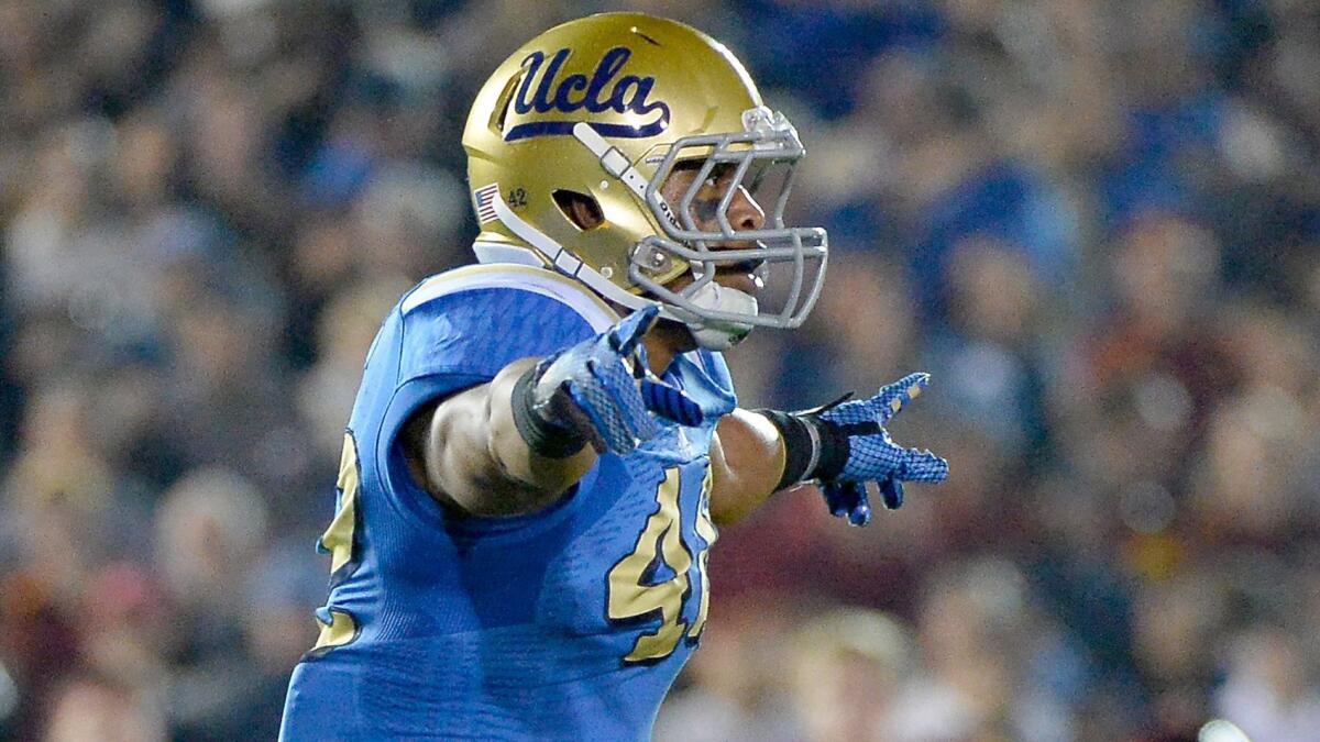 UCLA linebacker Kenny Young celebrates after making a tackle on fourth down during the Bruins' win over USC at the Rose Bowl on Nov. 22.
