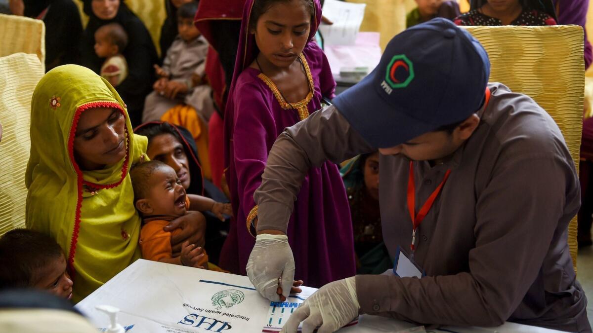 A paramedic takes blood samples for HIV tests at a government hospital in Ratodero, Pakistan, where hundreds of children have been infected with HIV since February.