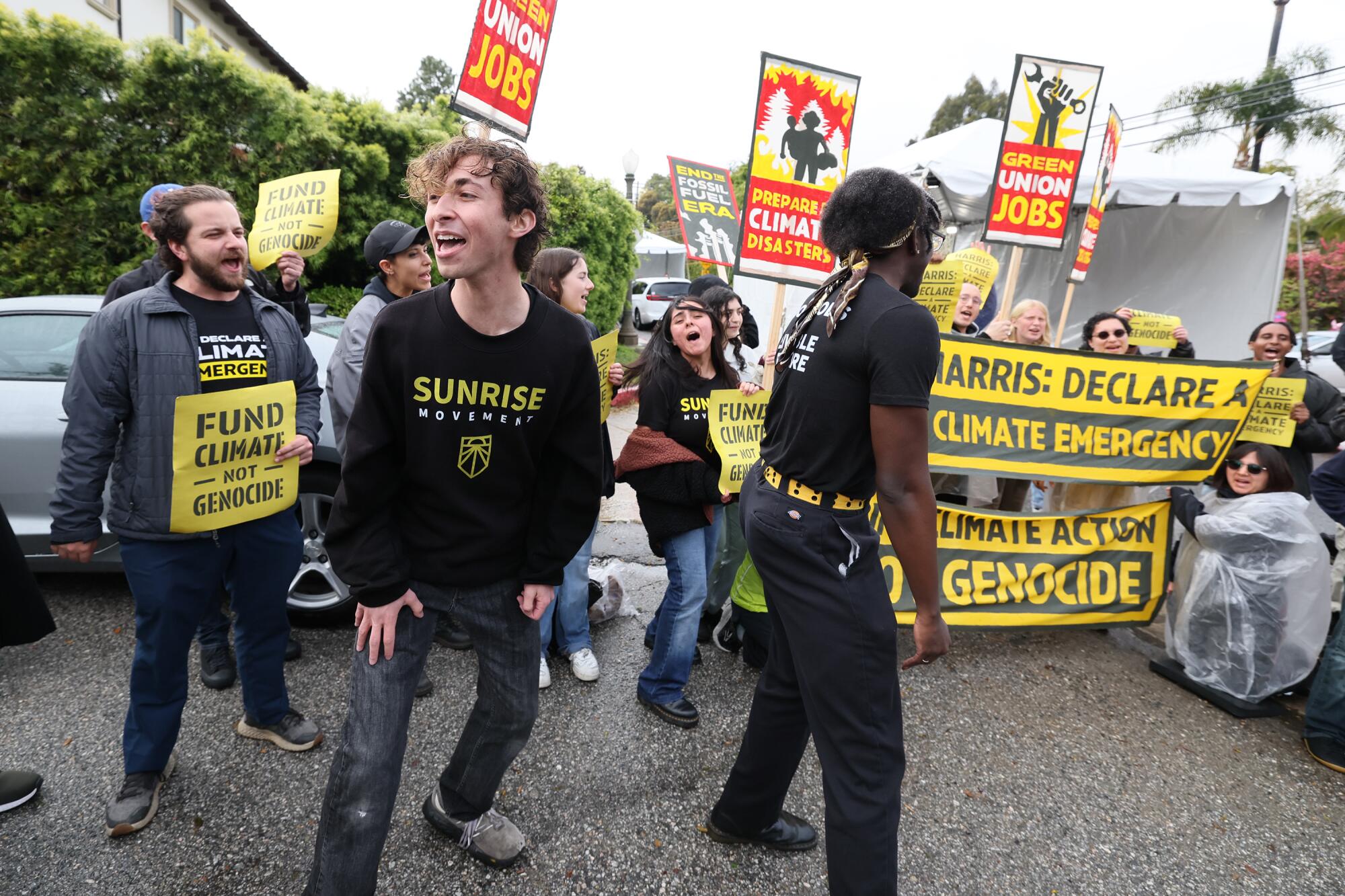 Students hold signs at a climate protest.