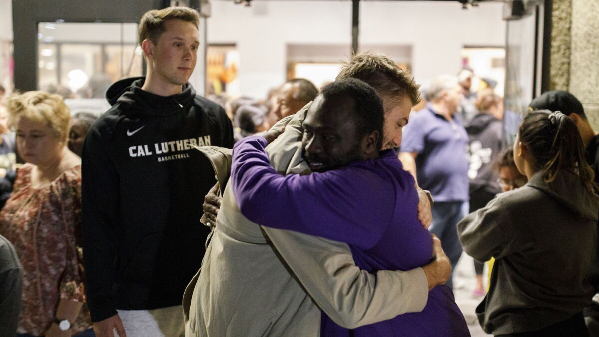 People console one another at a Cal Lutheran University vigil for victims of the Borderline Bar and Grill shooting in Thousand Oaks.