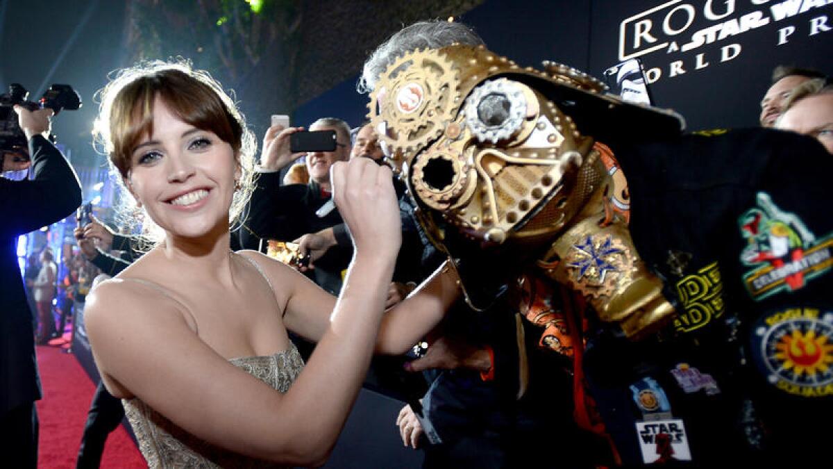 "Rogue One" star Felicity Jones signs Christopher "Dude Vader" Canole's helmet.