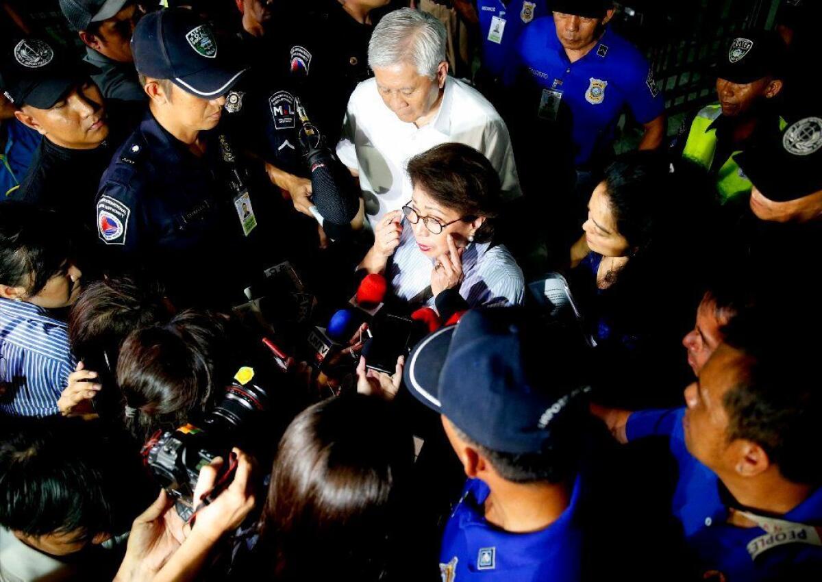 Former Philippine Supreme Court justice Conchita Carpio-Morales, center, talks to reporters upon arrival at the airport in Manila on May 21, after she was barred from entering Hong Kong