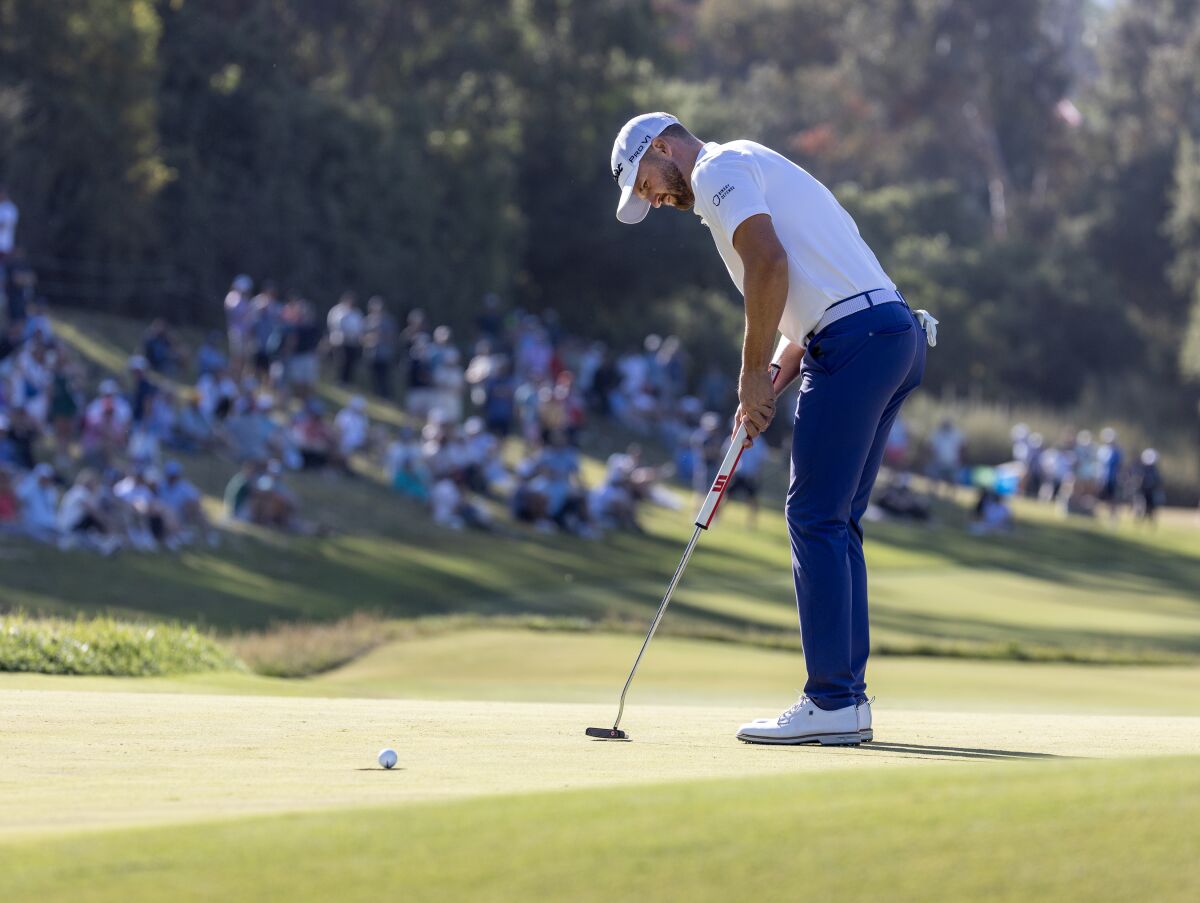 Wyndham Clark sinks a putt on the seventh hole at Los Angeles Country Club.