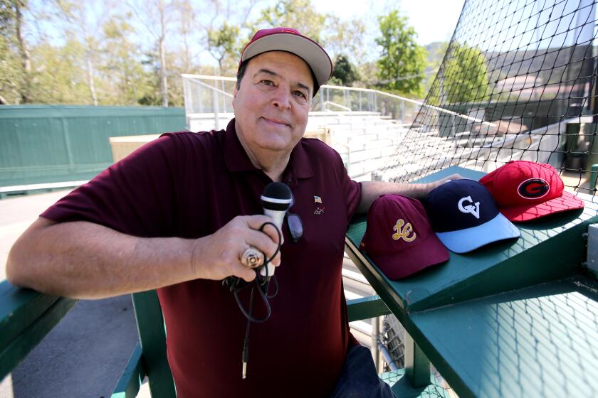 Area sports announcer Spiro Psaltis poses with a microphone at an empty Stengel Field in Glendale on Thursday, April 16, 2020.