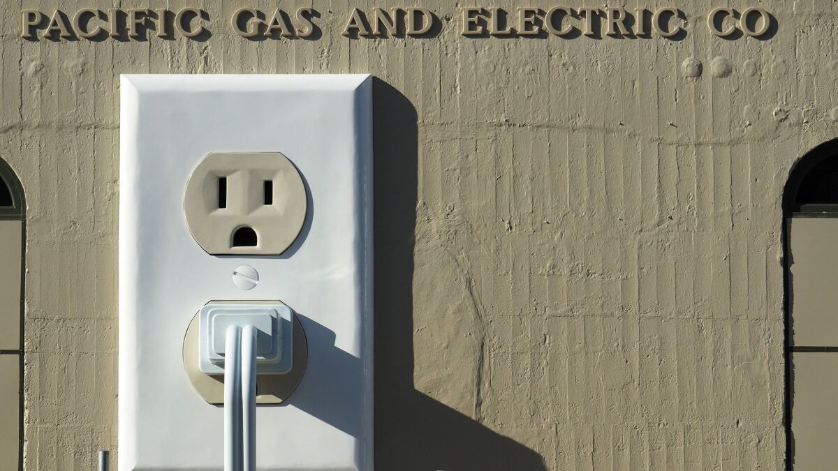 An art installation titled "Outlet-plug-cord" (2015) adorns the side of a Pacific Gas & Electric substation in Petaluma, Calif., in July 2015.
