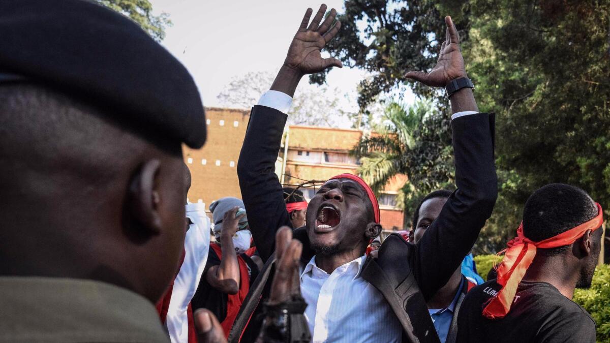 Makerere University students confront police during protests in Kampala, Uganda, on Tuesday. Students demonstrated against legislation to lift an age limit that would allow longtime President Yoweri Museveni to run for reelection.