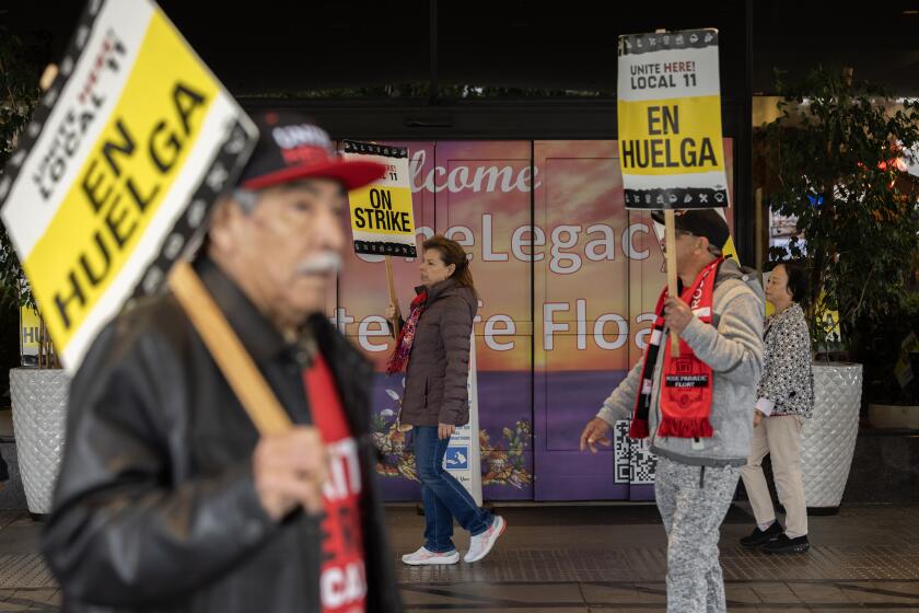 PASADENA, CA - DECEMBER 31: Workers take part in a planned around-the-clock, two-day strike at the Hilton Pasadena and nearby Hyatt Place in Pasadena, CA on Sunday, Dec. 31, 2023. The issues for the striking workers are wages, maintaining their health insurance, improving the pension and having a manageable workload. Since the pandemic, they say, hotels have cut services but also cut staffing creating an unmanageable workload. (Myung J. Chun / Los Angeles Times)