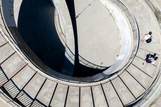 Santa Monica, CA - August 26: Beachgoers walk down the spiral staircase at Montana Ave.