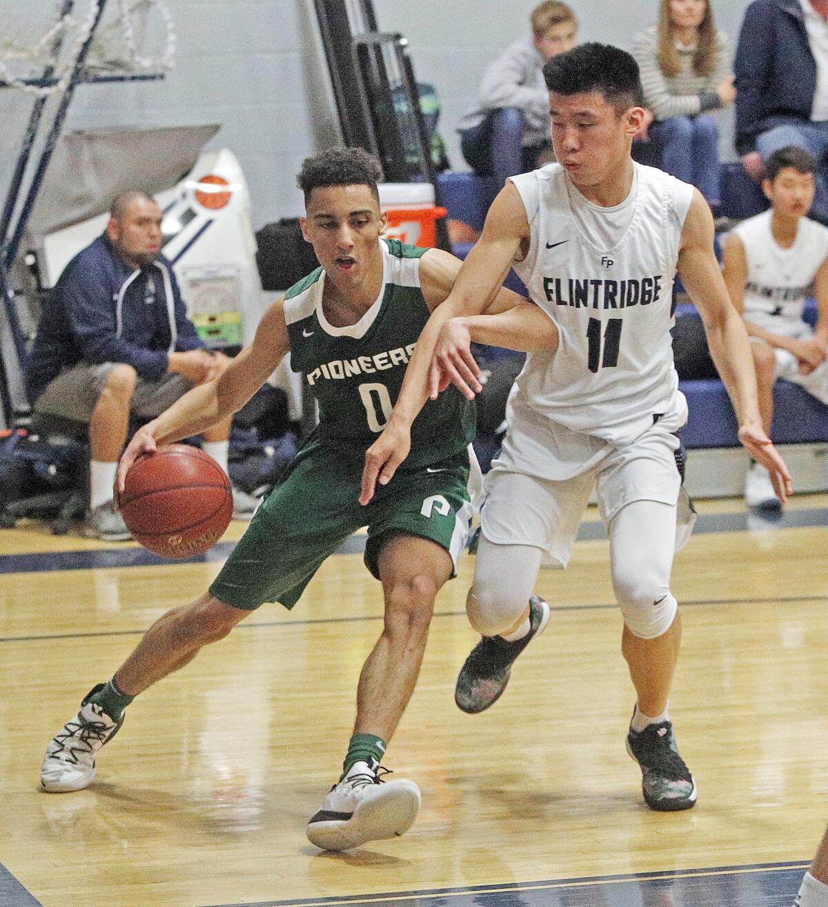 Providence's Jordan Shelley drives against tight defense by Flintridge Prep's Matthew Ho in a Prep League boys' basketball game at Flintridge Preparatory School on Monday, January 28, 2019.