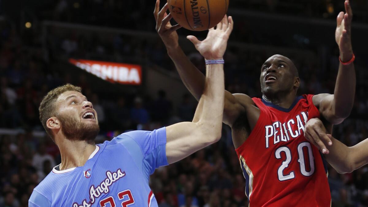 Clippers forward Blake Griffin, left, and New Orleans Pelicans forward Quincy Pondexter battle for a rebound during the Clippers' 107-100 victory at Staples Center on March 22, 2015.