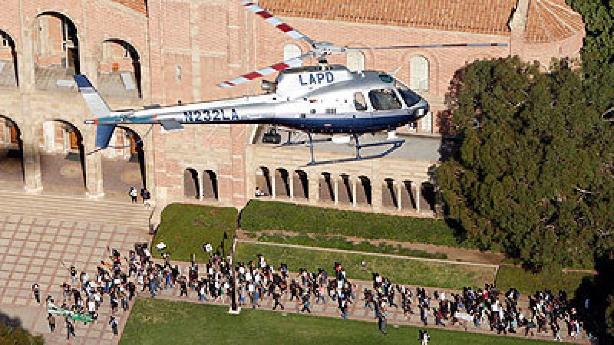 A Los Angeles Police Department helicopter keeps watch on protesters marching through the UCLA campus in Westwood.