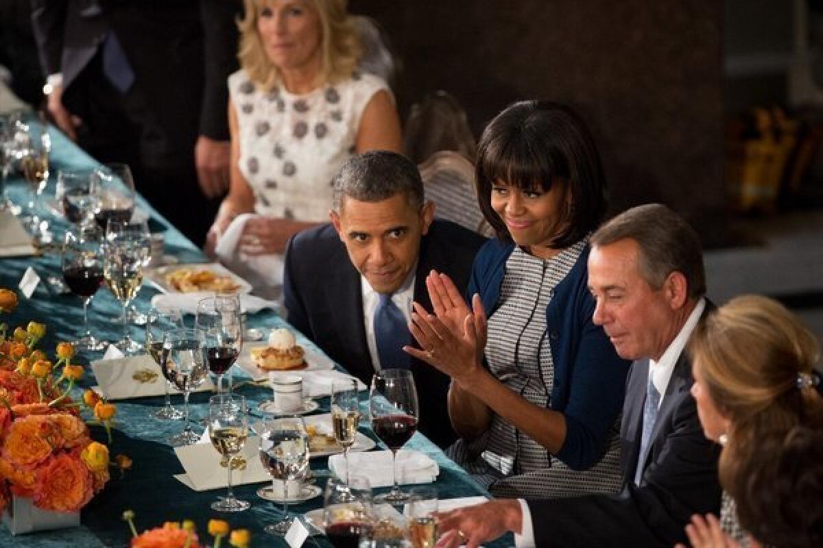 President Obama shares a moment with First Lady Michelle Obama and House Speaker John A. Boehner (R-Ohio) during the inaugural luncheon at the Capitol on Jan. 21.