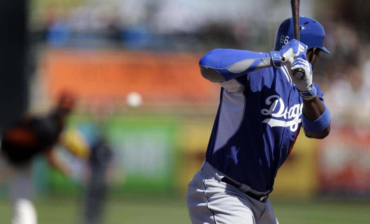 Dodgers outfielder Yasiel Puig eyes a pitch from Matt Cain of the San Francisco Giants during a spring training game on March 9.