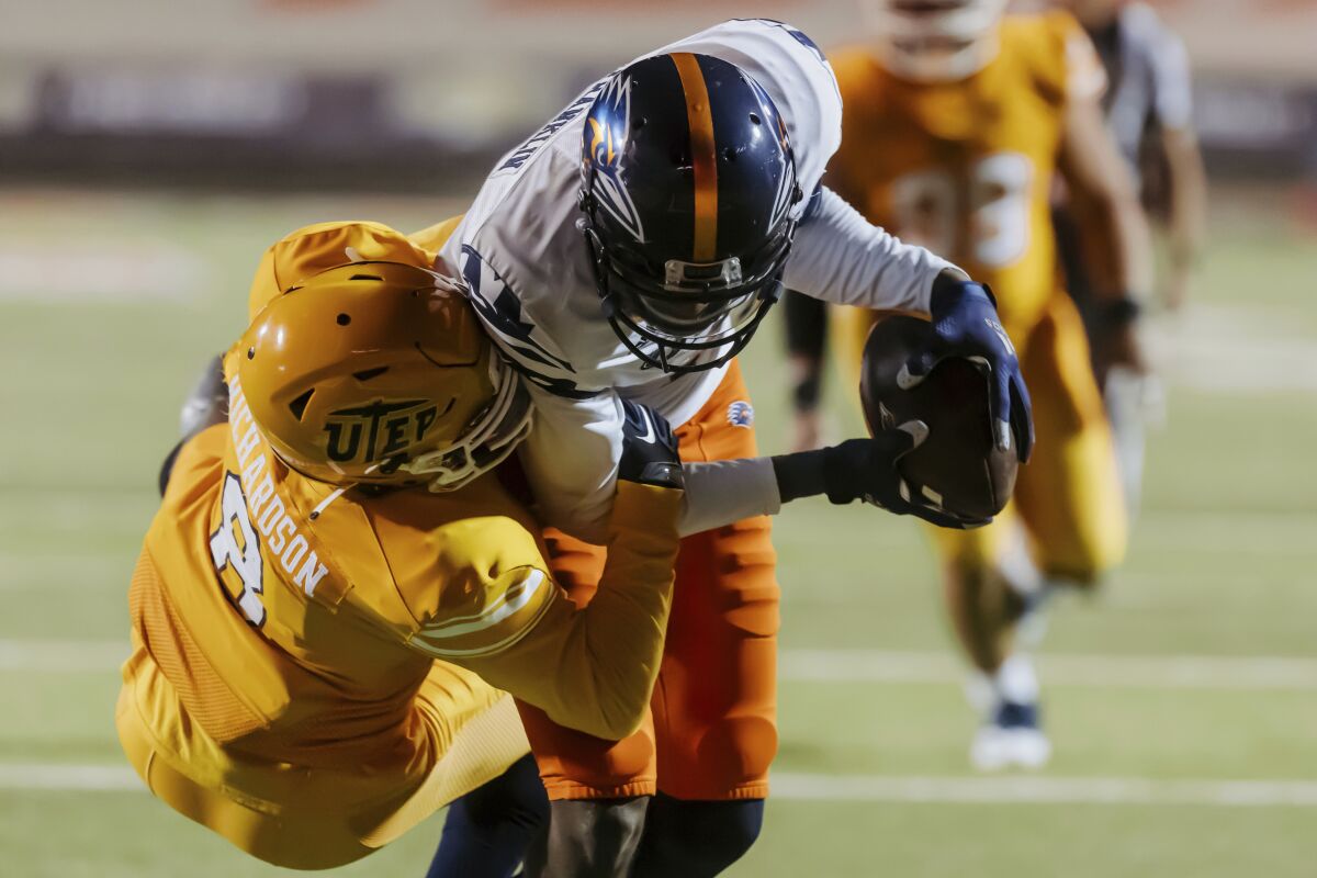 UTEP's Torey Richardson (8) tries to stop UTSA's Zakhari Franklin during an NCAA college football game in El Paso, Texas, Saturday, Nov. 6, 2021. (Gaby Velasquez/The El Paso Times via AP)