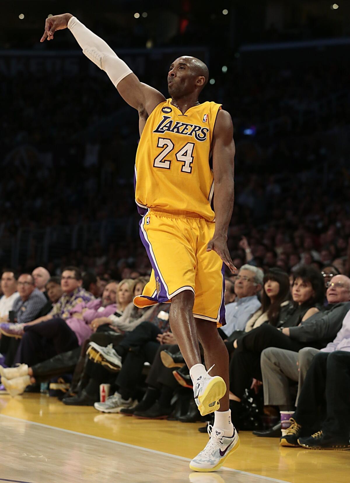Kobe Bryant follows through as he hits a three-pointer late in the game against the New Orleans Hornets.