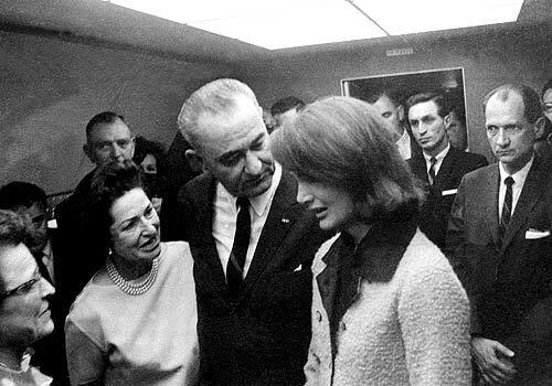 Lady Bird and Lyndon console Jacqueline Kennedy after President Kennedy was assassinated in Dallas on Nov. 22, 1963. Only moments before, Johnson took the oath of office to become president.