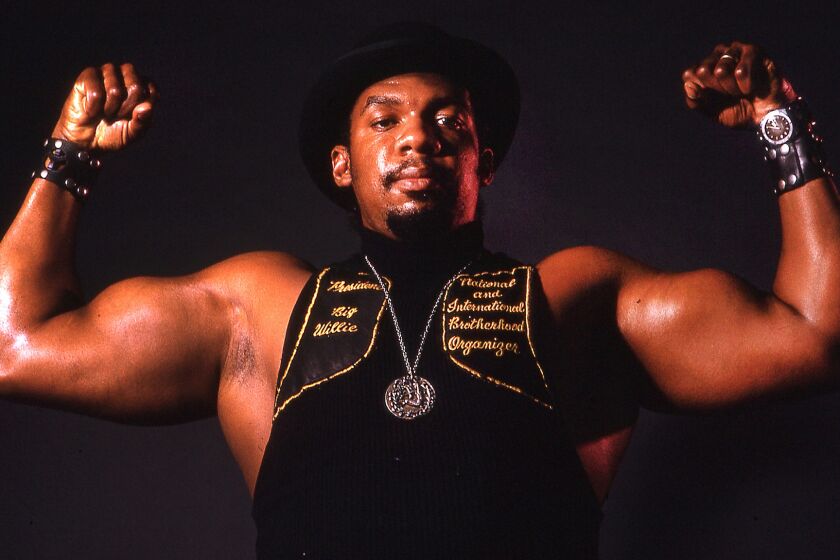 Big Willie Robinson, president of the International Brotherhood of Stree Racers, flexes his muscles during a photo shoot.in 1974.