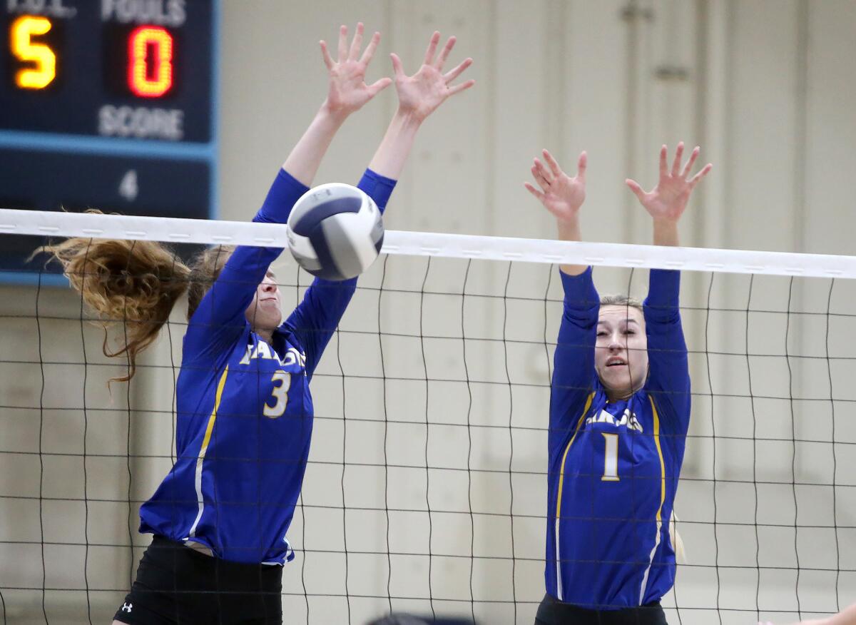 Fountain Valley's Juliette Bokor (3) blocks a shot with the help from Jenna Peterson in a Wave League match at Marina on Tuesday.