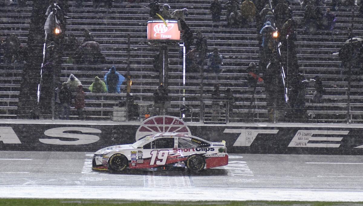 Carl Edwards (19) drives across the start-finish line under a yellow flag as rain falls during the NASCAR Sprint Cup Series race at Texas Motor Speedway on Nov. 6.