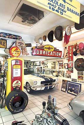 The iconic 1965 Ford Mustang GT 350 shares floor space with a 1949 Mercury flathead engine and a Gilmore Oil Co. gas pump.