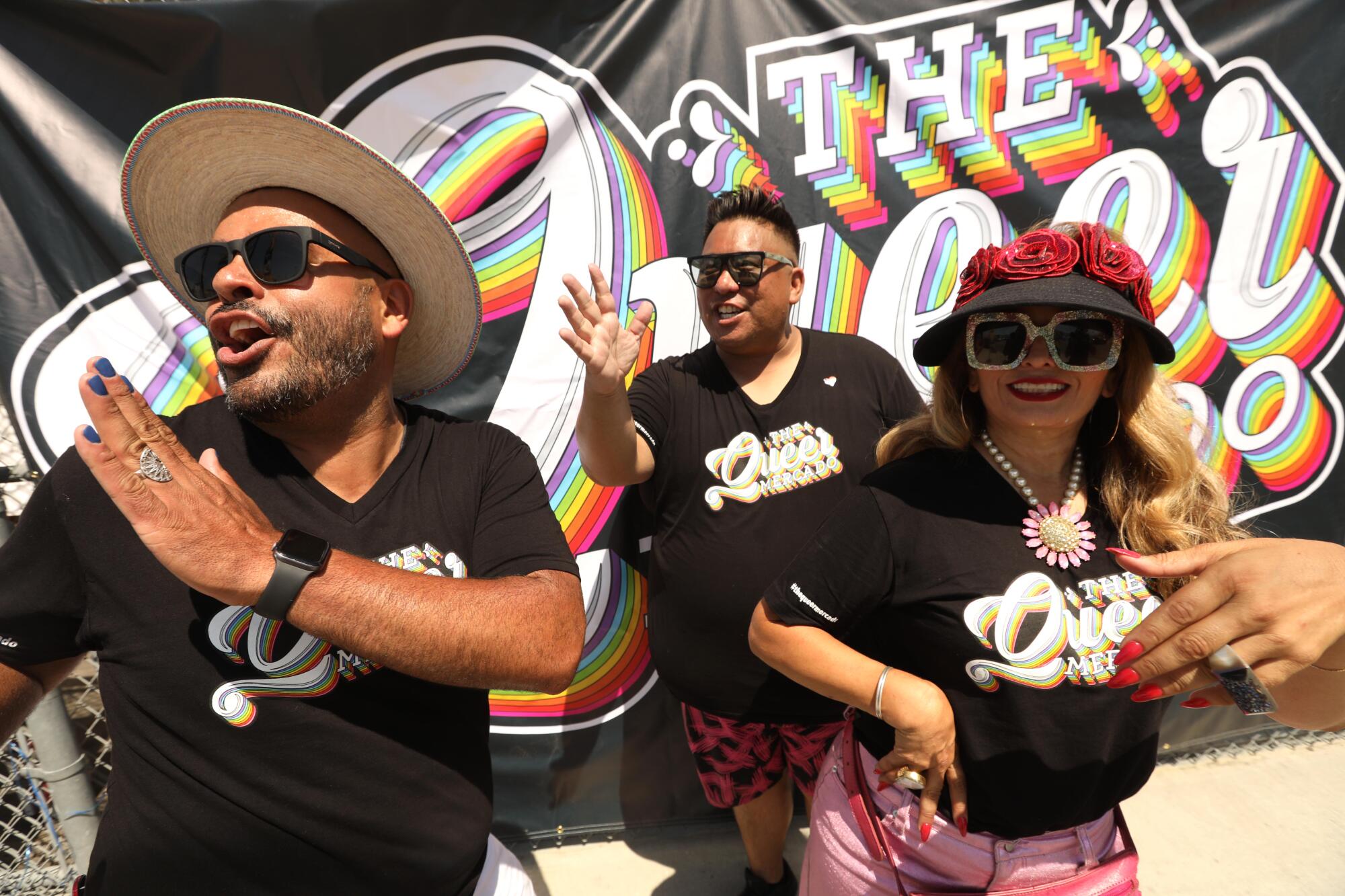 Gaudencio Marquez, left, Ryan Montez and Diana Diaz, co-founders of the Queer Mercado, wave to friends. 