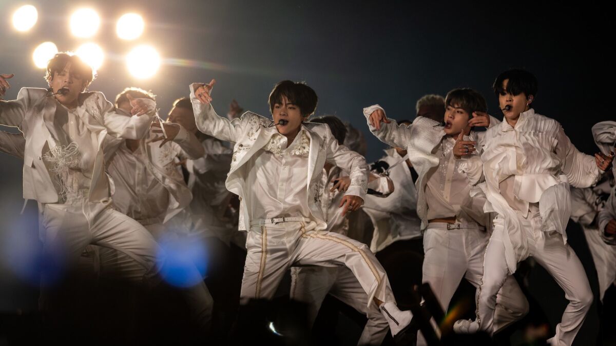 The hit K-pop band BTS performs to a crowd of more than 52,000 Saturday night at the Rose Bowl.