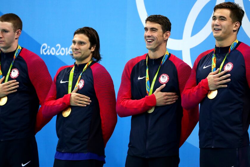 The U.S. men's 400-meter medley relay team -- (from left) Ryan Murphy, Cody Miller, Michael Phelps, Nathan Adrian -- listen to the national anthem after winning gold on Saturday night.