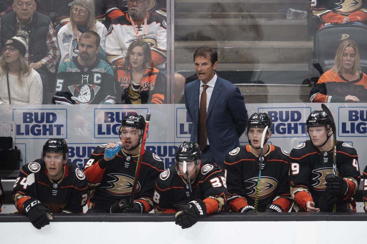 Ducks coach Dallas Eakins, top, yells instructions to his players during the third period against the Arizona Coyotes on Thursday at Honda Center.