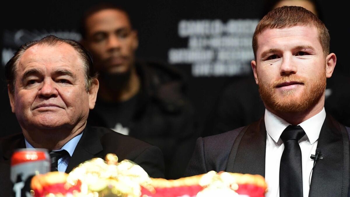 Canelo Alvarez is joined by his manager, Chepo Reynoso, during a news conference at Madison Square Garden.