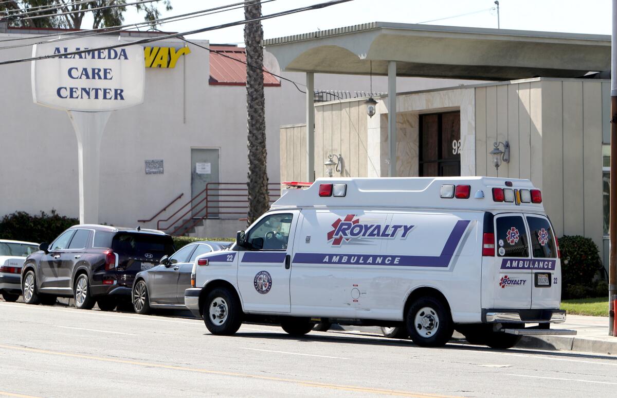 An ambulance drives away with a patient, whose condition was unknown, picked up from Alameda Care Center, 925 W. Alameda Ave. in Burbank, on Friday. The center has reported multiple positive cases of the novel coronavirus among its senior residents, and two have died.