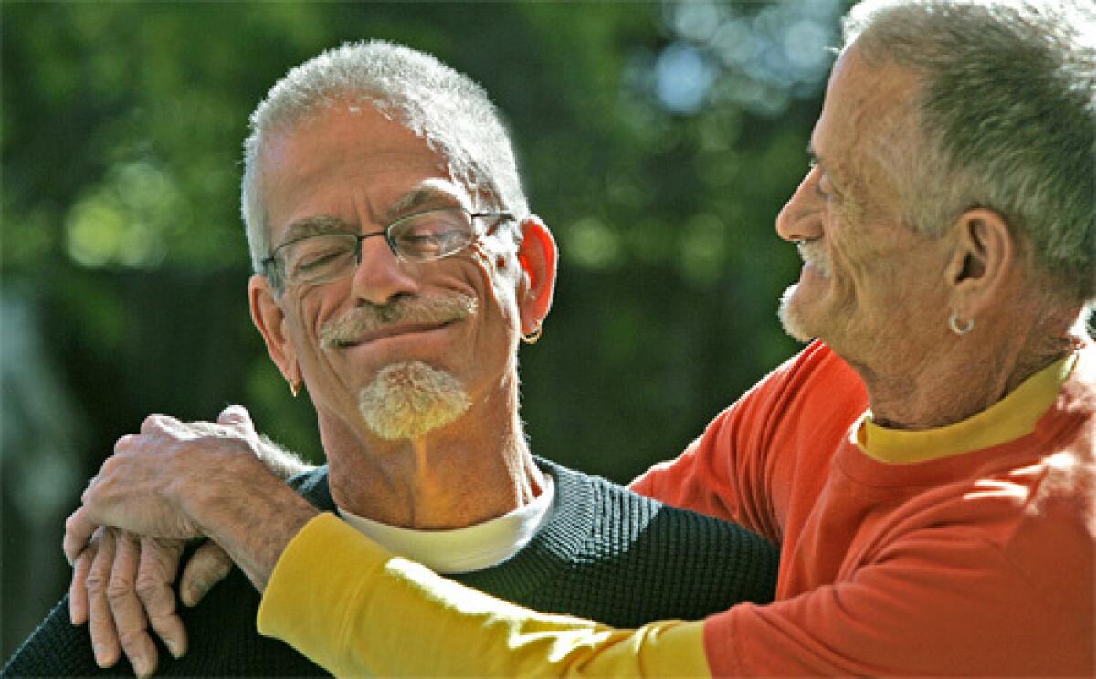 WERE STILL HERE: Dennis Golay, 60, left, and Larry Gibson, 63, in the garden of their Palm Springs home. Both men tested positive for HIV in the days before antiretroviral drugs.