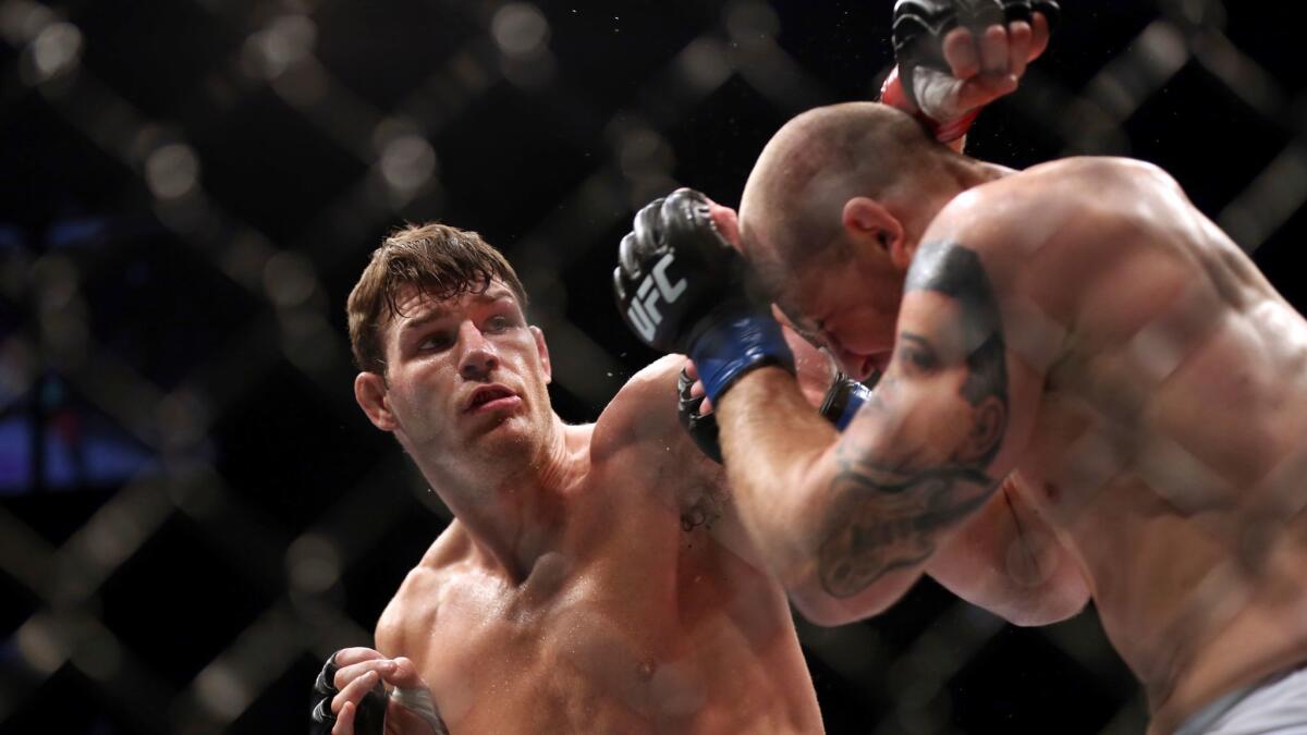 Michael Bisping, left, fights Alan Belcher at UFC 159 in Newark, N.J., on April 27, 2013.