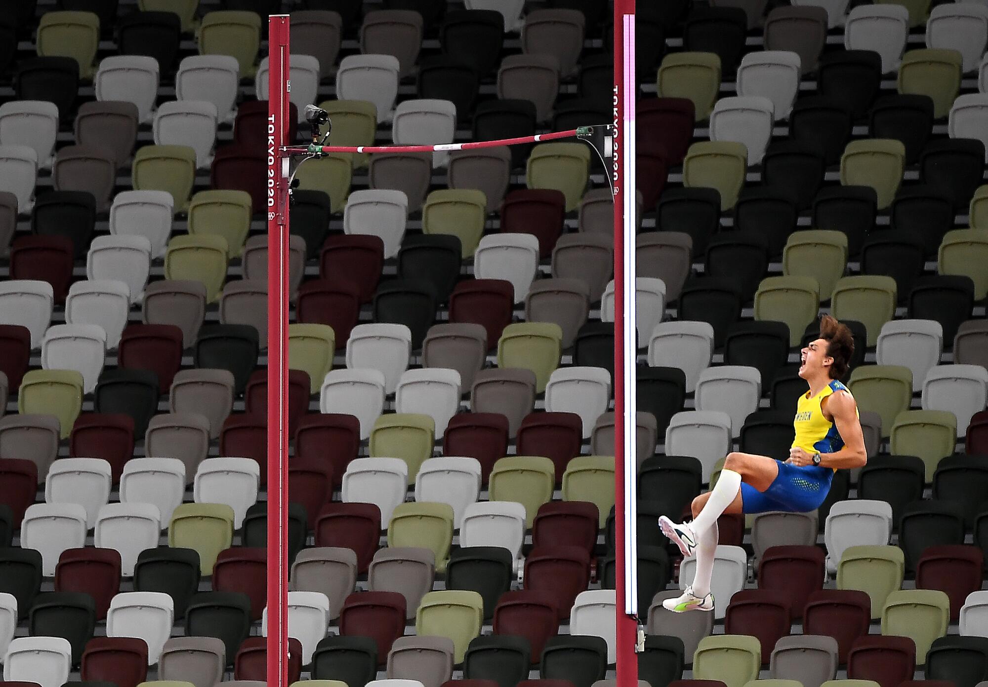 Sweden's Armand Duplantis celebrates after clearing the bar to win the gold medal in the pole vault