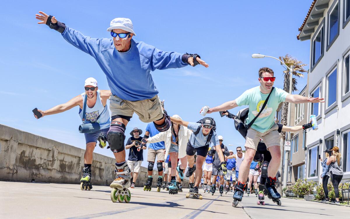 Dr. John "Slomo" Kitchin skates down the Pacific Beach Boardwalk with fans in-tow during Slomo Day on April 8.