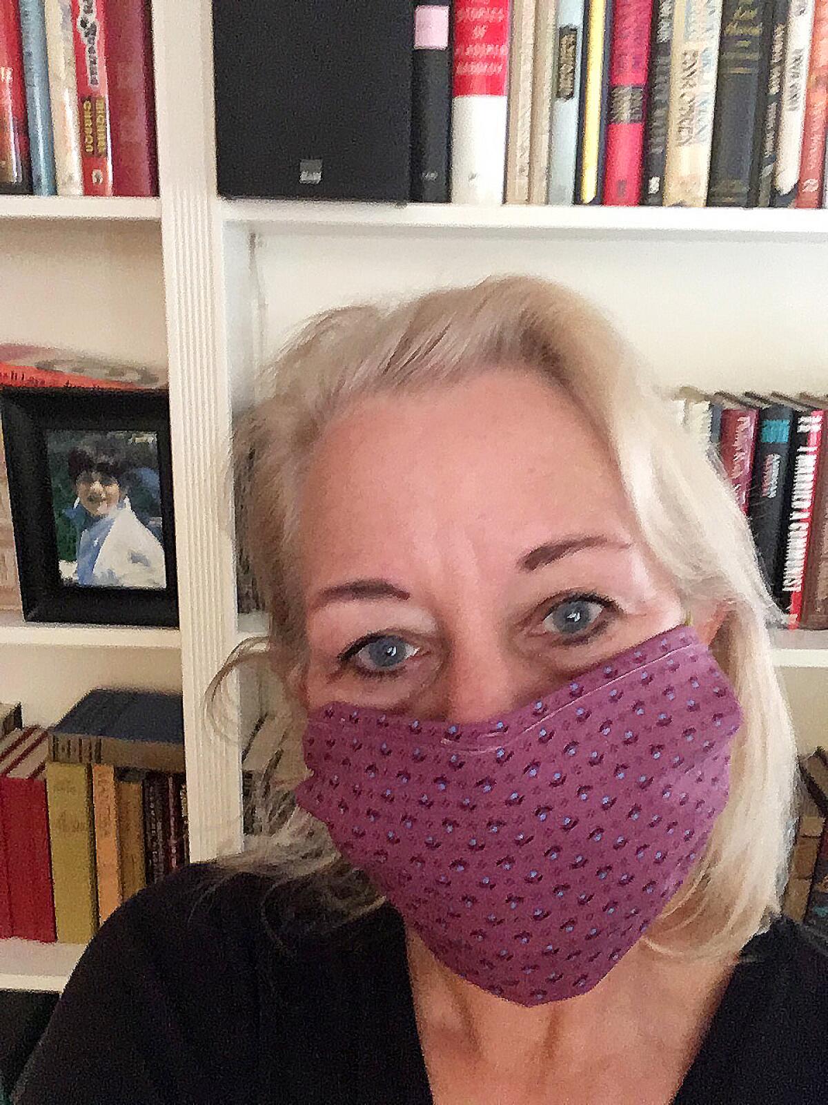 Laura Lipppman sports a no-sew mask she learned how to make on Twitter out of a quilt she started 37 years ago.